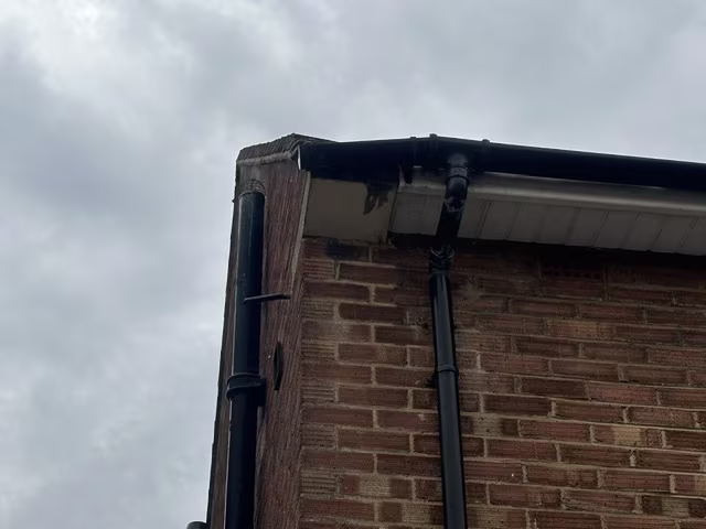 Clean black fascia, soffit and gutter on a brick house in Luton