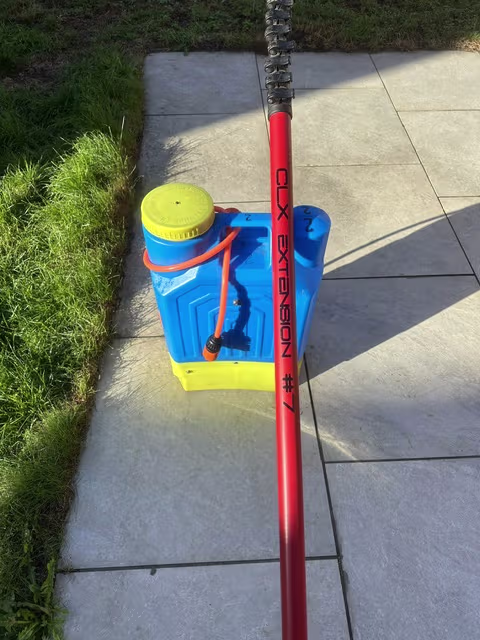 Patio slabs being treated with a cleaning sprayer in Luton