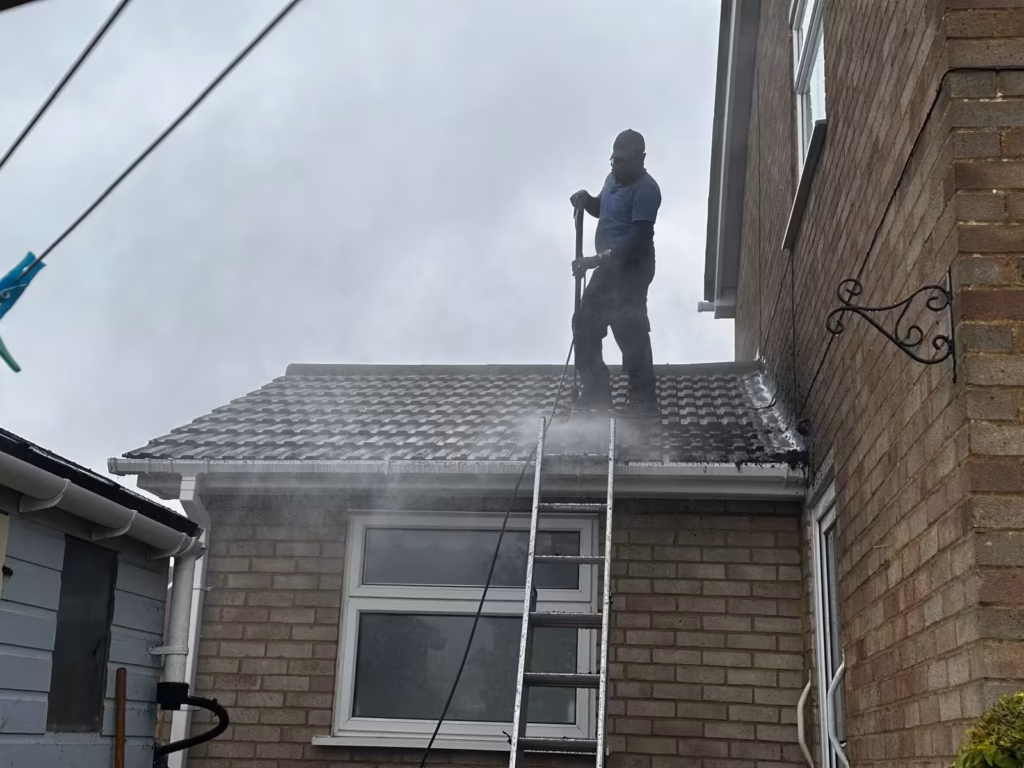 Roof cleaning in progress on a brick house in Luton