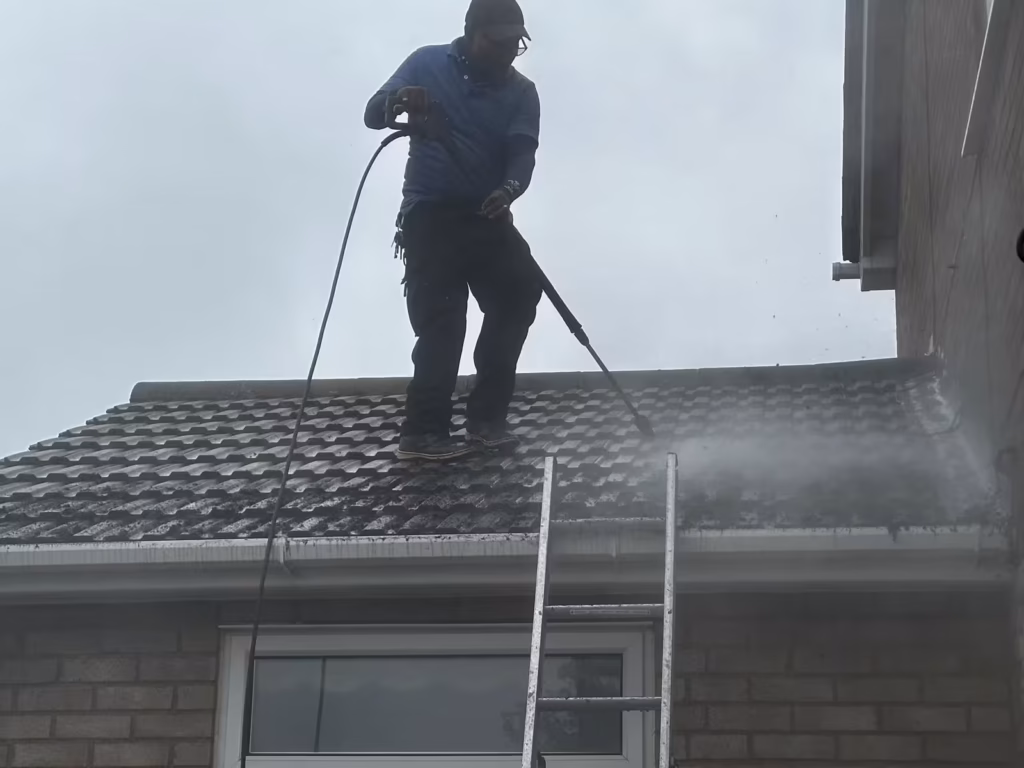 Roof tiles being cleaned and moss removed on a house in Luton